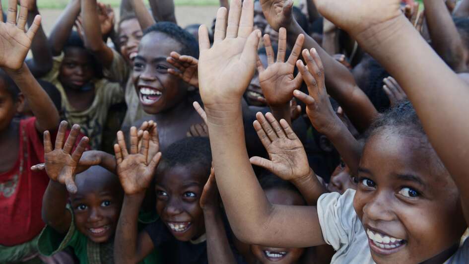 Joyful greeting of children in the project area Ravomena, Madagascar.