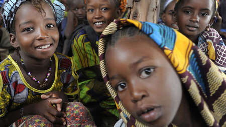 Four girls are smiling in the camera