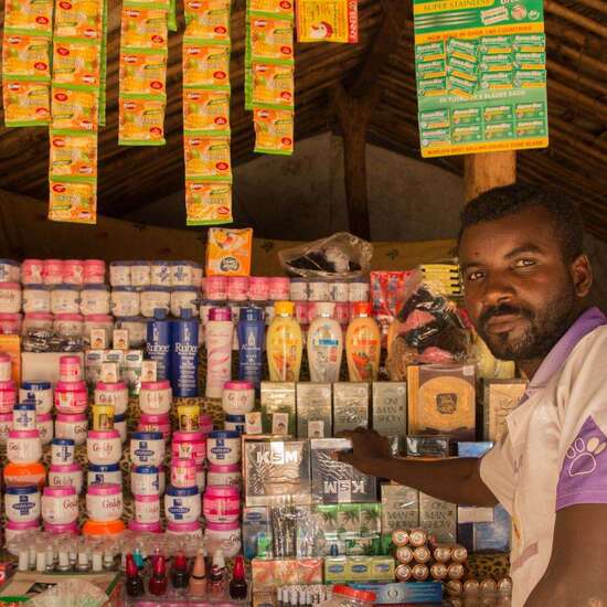 A small trader in front of his store.