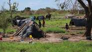 Menschen an einer provisorischen Unterkunft nach Zyklon Idai in Lamego, Mosambik.