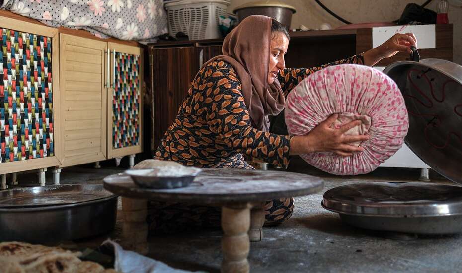 Goze in her kitchen, making bread for lunch in Sibaye village, Sinjar, Ninewa 
