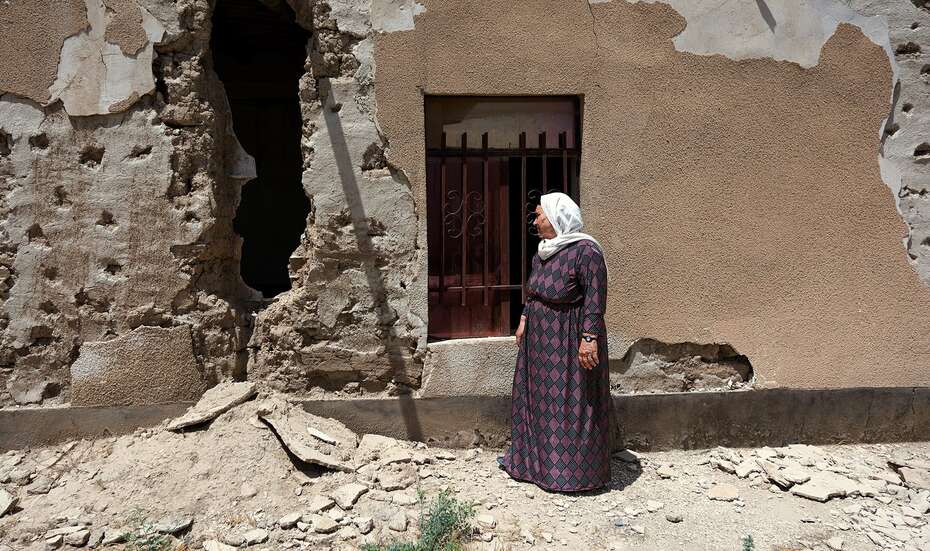Shirin at the destroyed structure of her home in Digure village, Sinjar district, Ninewa. 