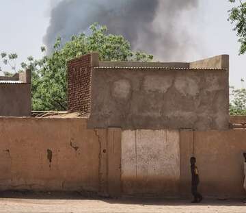 Smoke rises above houses
