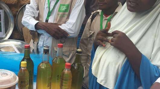 People standing around table with peanut products.