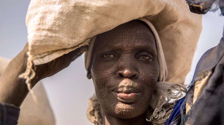 A woman at the refugee camp in Bentiu receives groceries.