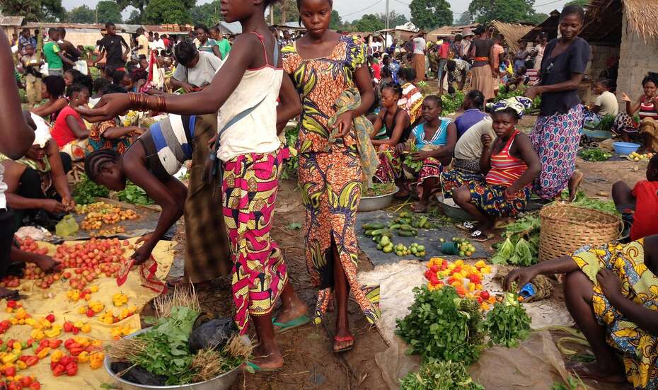 Earning an income by selling produce at the market.