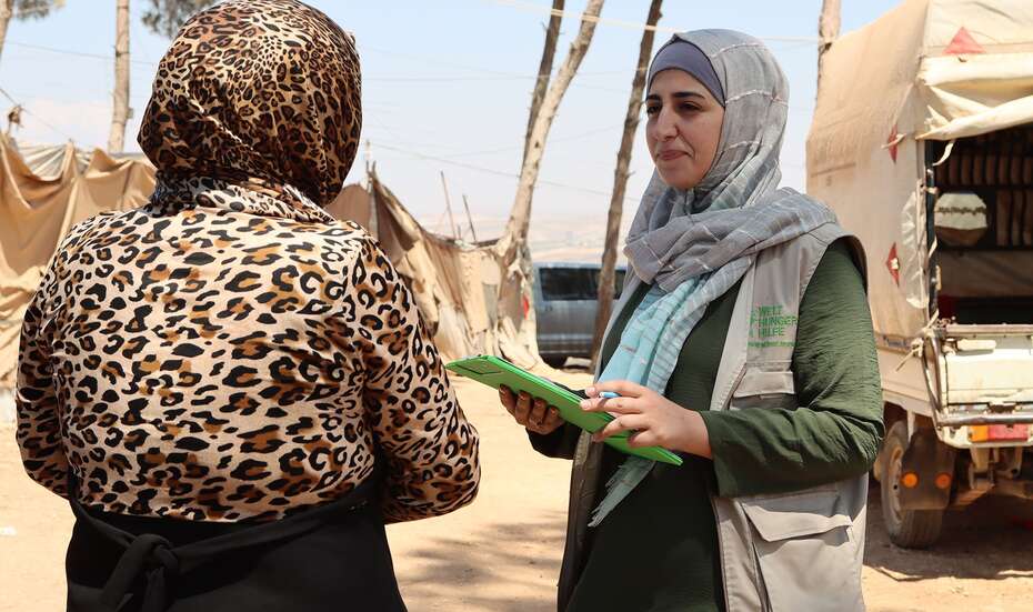 WHH worker talking to a woman in a refugee camp in Syria