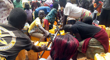 Refugees at a water point in the Bidibidi camp
