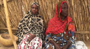 Two woman in a tent.