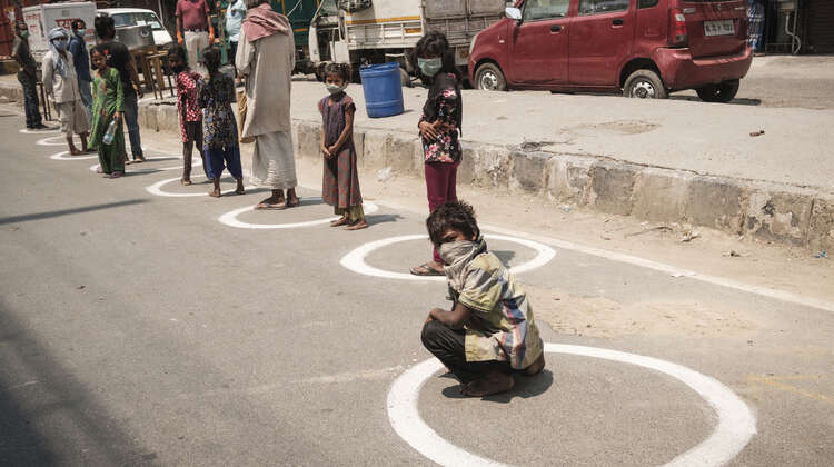 People in line for food in Delhi, India