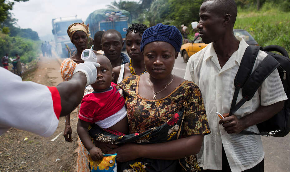 A woman and her child at an Ebola checkpoint