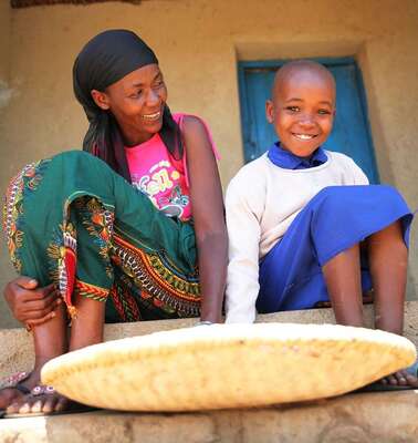 A woman and a girl are sitting on stairs.