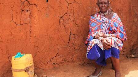 A man in front of a cabin