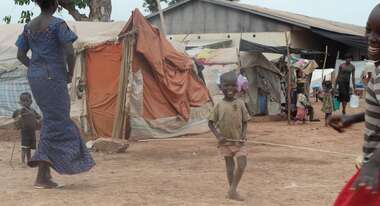 A child playing between tents at the airport in Bangui.