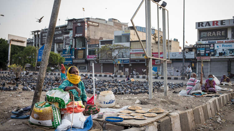 A woman sits on the street.