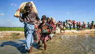 Rohingya refugees walking in a long line
