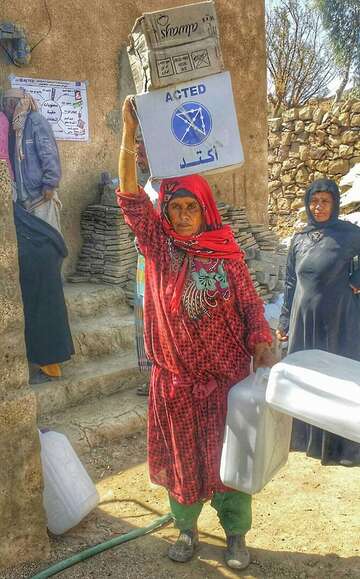 A woman receives a hygiene kits in Yemen