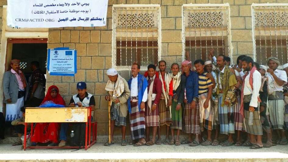 Beneficiaries lining up at a cash distribution in Yemen