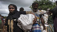 A woman in Hakimpara refugee camp in Bangladesh with a sack full of fuel. 