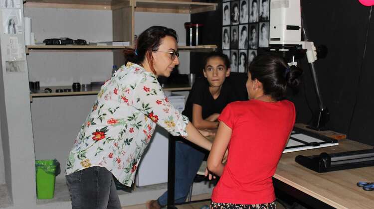 Emel Ernalbant talking to two girls