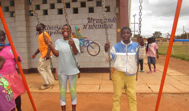 Zwei Kinder spielen auf einer Schaukel, Malawi 2021.