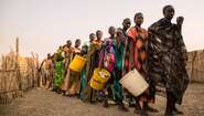 People queue up at a distribution of groceries at the refugee camp in Bentiu.