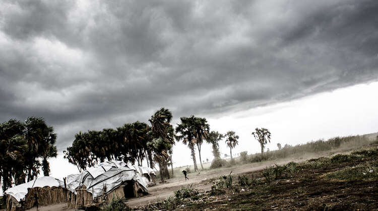 Dark grey clouds over a rugged landscape