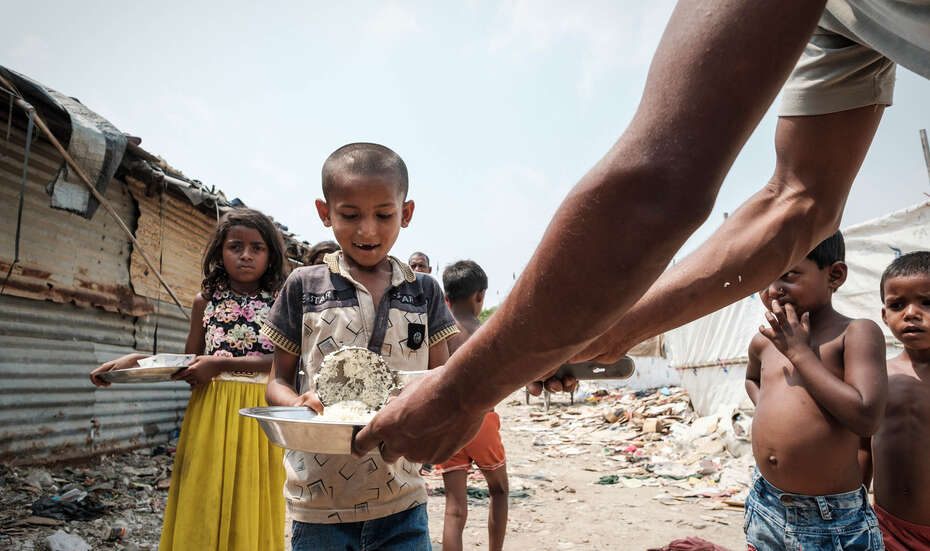 A smiling boy at a food distribution point