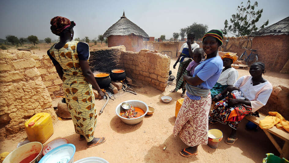 Women boil freshly harvested fruit and vegetables to create healthy food